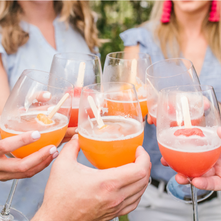 Easy and Refreshing Way to Serve Wine at a Barbecue Wine Bottle in ice Popsicles in Glass Pouring Wine