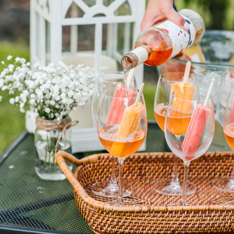 Easy and Refreshing Way to Serve Wine at a Barbecue Wine Bottle in ice Popsicles in Glass Pouring Wine