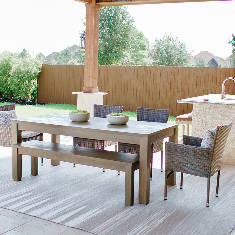 gray outdoor table, wicker chairs and bench